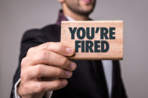 Man with you're fired sign for fire your agency post